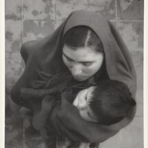 An overhead view of a mother and child embracing